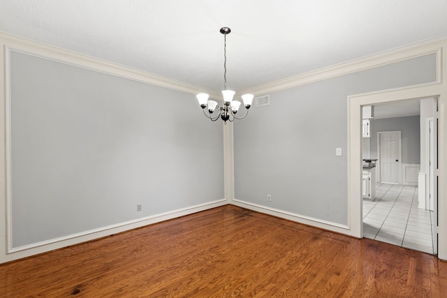 3318 Teawick Ct, Houston, TX 77068 - empty room featuring ornamental molding, a chandelier, and wood finished floors