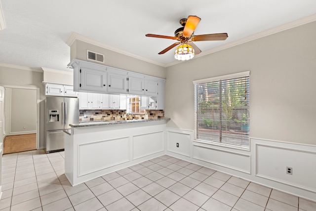 3318 Teawick Ct, Houston, TX 77068 - kitchen with stainless steel fridge, light tile patterned floors, a peninsula, ceiling fan, and white cabinetry