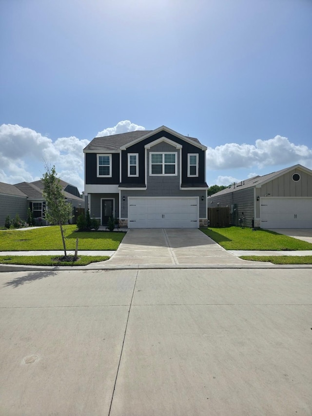 11407 Prairie Walk Dr, Houston, TX 77048 - view of front of house featuring a garage, a front lawn, driveway, and stone siding