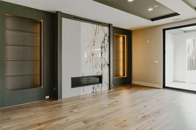 7302 Schiller St, Houston, TX 77055 - unfurnished living room featuring wood finished floors, a high end fireplace, and recessed lighting