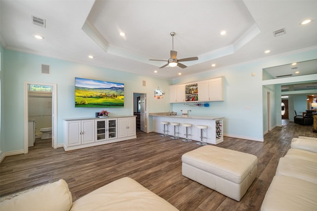 17383 Harbor Dr, Montgomery, TX 77356 - living area with ornamental molding, wood finished floors, a raised ceiling, a ceiling fan, and recessed lighting