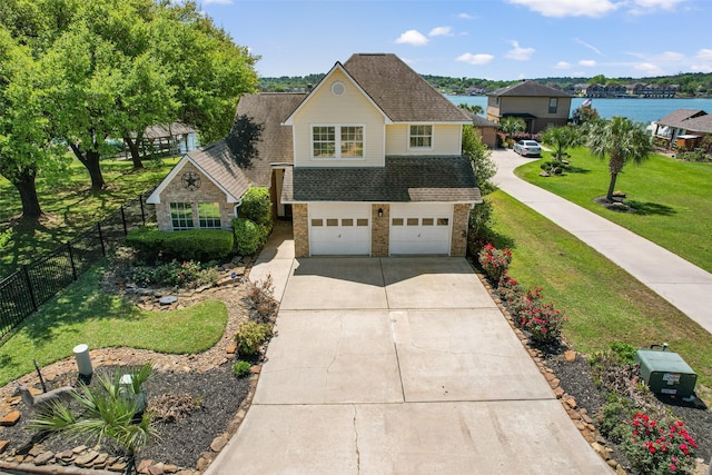 17383 Harbor Dr, Montgomery, TX 77356 - traditional-style home featuring roof with shingles, driveway, a garage, and brick siding