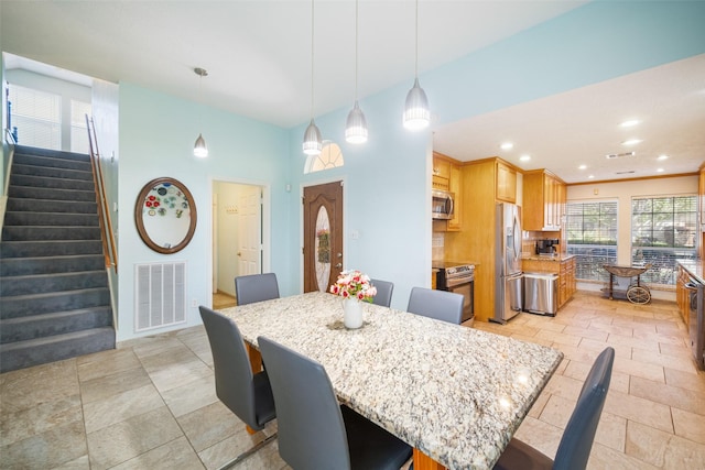 17383 Harbor Dr, Montgomery, TX 77356 - dining area featuring stairway, stone tile floors, recessed lighting, and a high ceiling