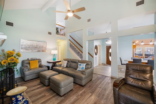 17383 Harbor Dr, Montgomery, TX 77356 - living room with stairway, ceiling fan, wood finished floors, high vaulted ceiling, and beamed ceiling