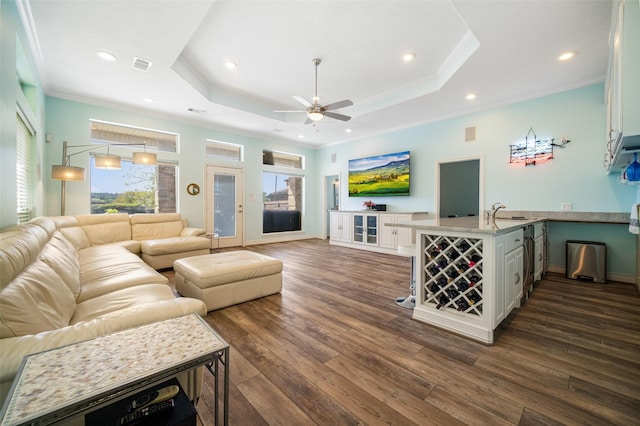 17383 Harbor Dr, Montgomery, TX 77356 - living room with ceiling fan, a raised ceiling, dark wood-style floors, ornamental molding, and recessed lighting