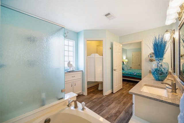 17383 Harbor Dr, Montgomery, TX 77356 - bathroom with vanity, wood finished floors, a shower stall, and ensuite bathroom