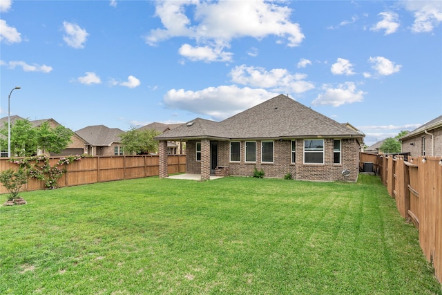 19815 Caprock Falls Ct, Cypress, TX 77433 - back of house with a patio, brick siding, a fenced backyard, and a shingled roof