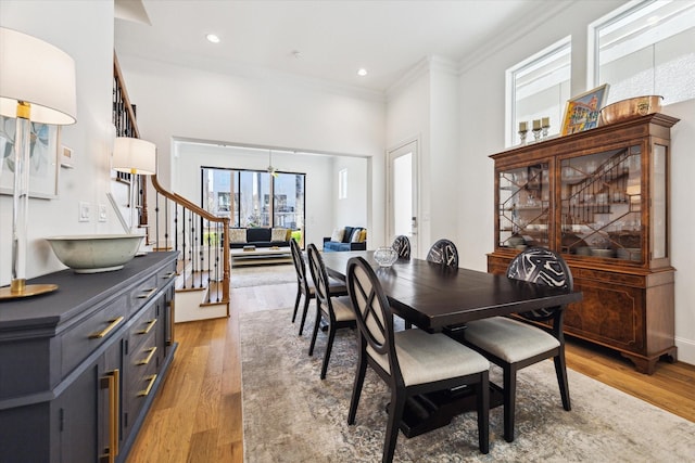 1240 W 16th St, Houston, TX 77008 - dining room featuring crown molding, light wood-style floors, stairs, a high ceiling, and recessed lighting