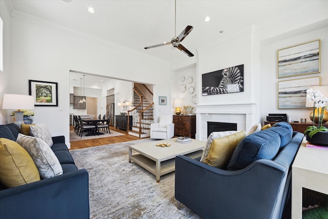 1240 W 16th St, Houston, TX 77008 - living area featuring ornamental molding, stairway, a fireplace, light wood-style floors, and recessed lighting