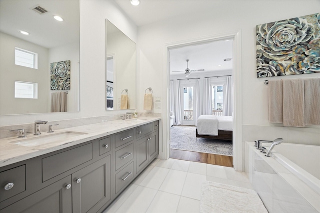1240 W 16th St, Houston, TX 77008 - bathroom with double vanity, tile patterned flooring, a garden tub, ceiling fan, and connected bathroom