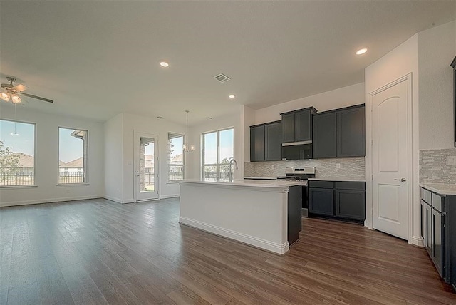 2040 Terra Rose Dr, Katy, TX 77493 - kitchen with backsplash, ceiling fan, open floor plan, dark wood finished floors, and recessed lighting