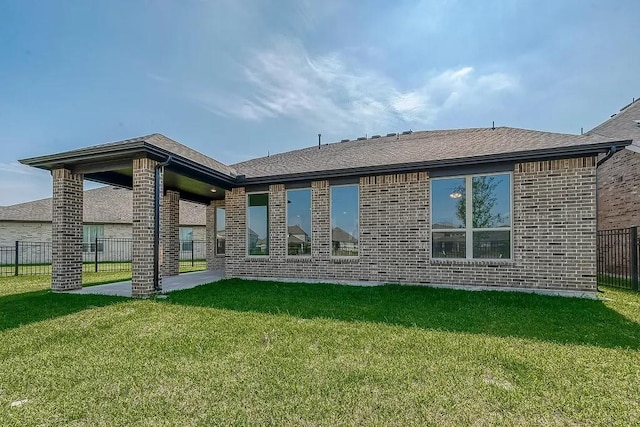 2040 Terra Rose Dr, Katy, TX 77493 - back of property featuring brick siding, a patio area, and a shingled roof
