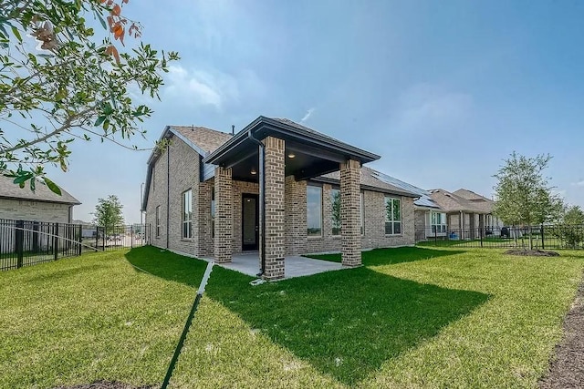 2040 Terra Rose Dr, Katy, TX 77493 - rear view of property featuring brick siding, a fenced backyard, and a patio area