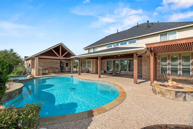 3211 Lakes Of Katy Ln, Katy, TX 77493 - view of swimming pool featuring an outdoor fire pit, a patio, and a pool with connected hot tub