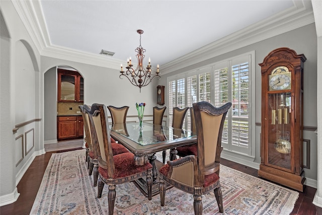3211 Lakes Of Katy Ln, Katy, TX 77493 - dining room featuring a chandelier, crown molding, and dark wood-type flooring
