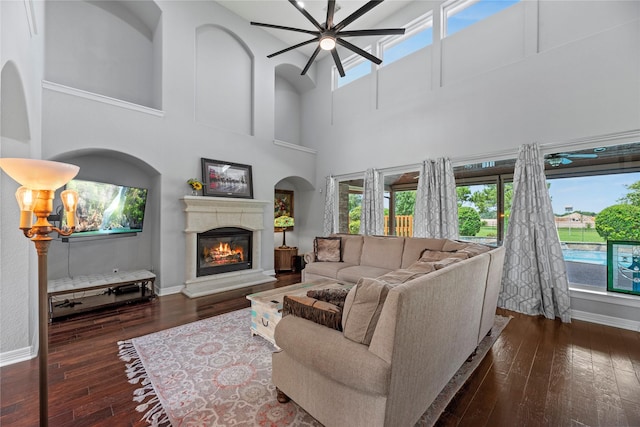 3211 Lakes Of Katy Ln, Katy, TX 77493 - living room with plenty of natural light, ceiling fan, a towering ceiling, a glass covered fireplace, and wood-type flooring