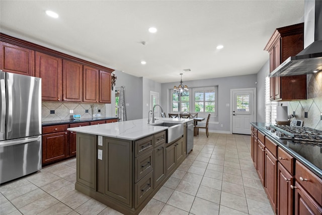 3211 Lakes Of Katy Ln, Katy, TX 77493 - kitchen with appliances with stainless steel finishes, wall chimney exhaust hood, backsplash, recessed lighting, and a kitchen island with sink