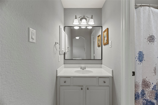 3211 Lakes Of Katy Ln, Katy, TX 77493 - full bathroom featuring vanity, a textured wall, and curtained shower