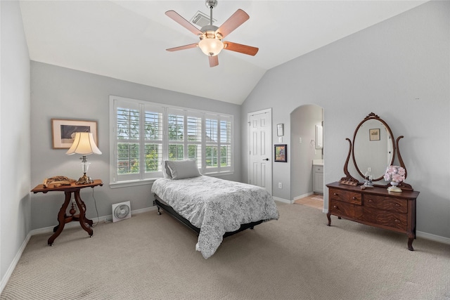 3211 Lakes Of Katy Ln, Katy, TX 77493 - bedroom with arched walkways, vaulted ceiling, light colored carpet, a ceiling fan, and ensuite bathroom