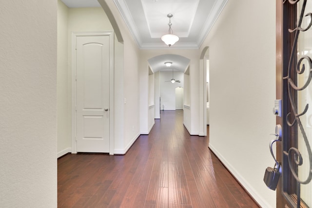 15 Floral Hills Ln, Fulshear, TX 77441 - foyer featuring arched walkways, dark wood-style flooring, a tray ceiling, a ceiling fan, and ornamental molding