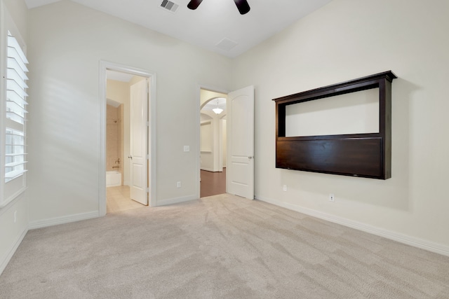 15 Floral Hills Ln, Fulshear, TX 77441 - unfurnished bedroom with carpet floors, connected bathroom, and a ceiling fan