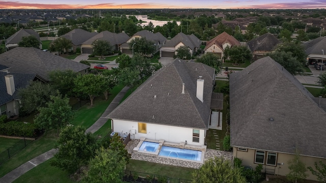 15 Floral Hills Ln, Fulshear, TX 77441 - aerial view at dusk of a residential view and view of pool area