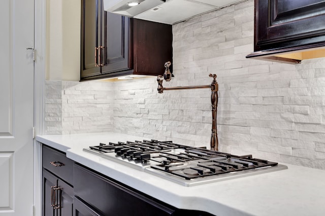 15 Floral Hills Ln, Fulshear, TX 77441 - kitchen with light countertops, decorative backsplash, stainless steel gas cooktop, and premium range hood