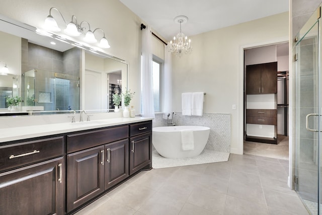 15 Floral Hills Ln, Fulshear, TX 77441 - full bathroom with a stall shower, vanity, tile patterned floors, a soaking tub, and a chandelier