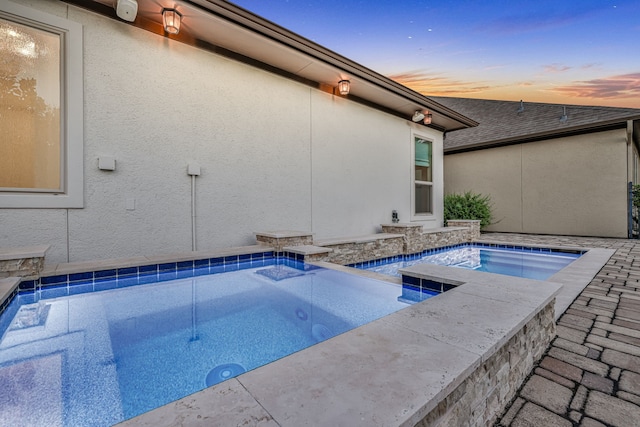 15 Floral Hills Ln, Fulshear, TX 77441 - pool at dusk with an outdoor pool and an in-ground hot tub