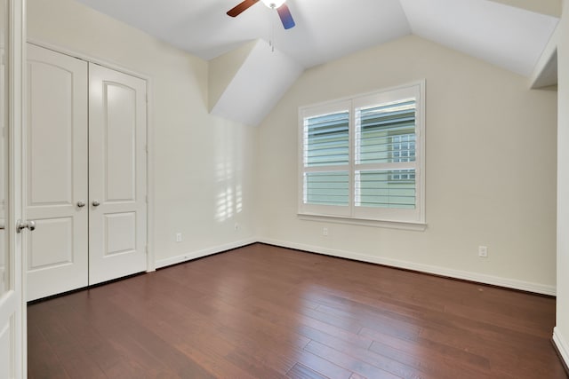 15 Floral Hills Ln, Fulshear, TX 77441 - unfurnished bedroom with lofted ceiling, dark wood-style floors, and a ceiling fan