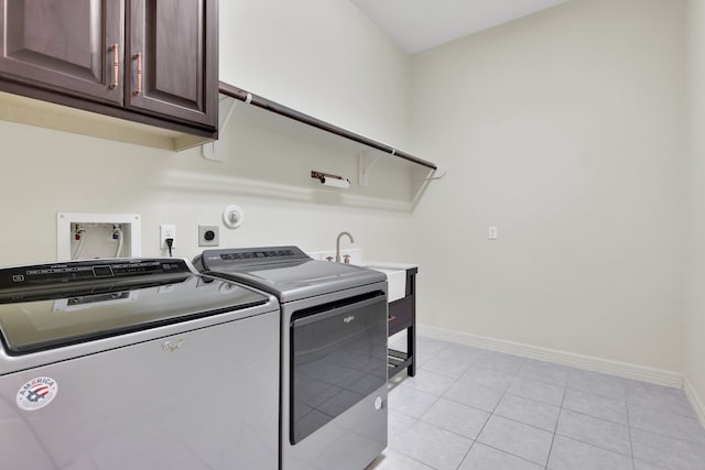15 Floral Hills Ln, Fulshear, TX 77441 - washroom with cabinet space, separate washer and dryer, and light tile patterned floors