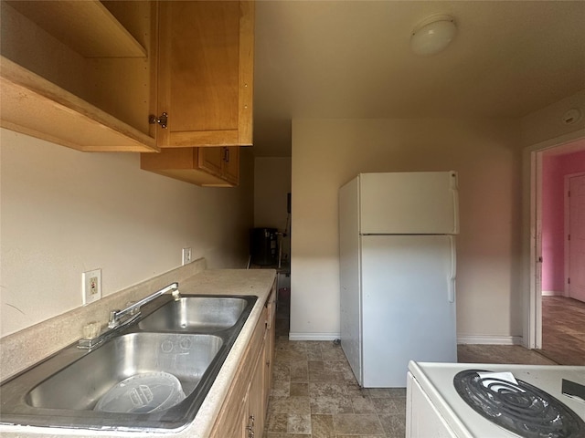 4522 Sage Cir, Baytown, TX 77521 - kitchen featuring freestanding refrigerator, stove, light countertops, and stone finish flooring