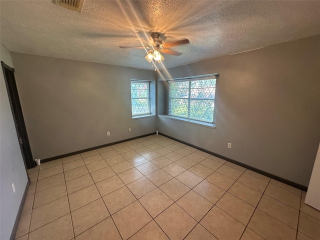 4522 Sage Cir, Baytown, TX 77521 - spare room with a ceiling fan, a textured ceiling, and light tile patterned flooring