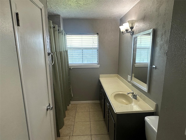 4522 Sage Cir, Baytown, TX 77521 - bathroom featuring healthy amount of natural light, vanity, tile patterned flooring, a textured ceiling, and a shower with shower curtain