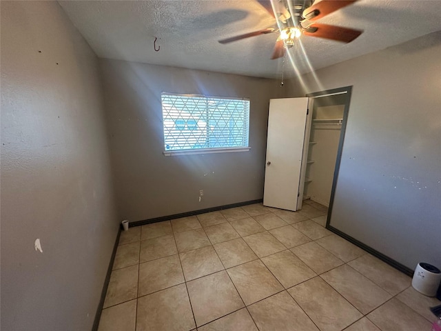 4522 Sage Cir, Baytown, TX 77521 - unfurnished bedroom featuring a textured ceiling, a ceiling fan, and light tile patterned floors