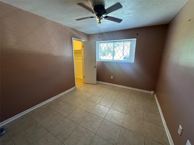 4522 Sage Cir, Baytown, TX 77521 - empty room featuring a textured ceiling, ceiling fan, and light tile patterned floors