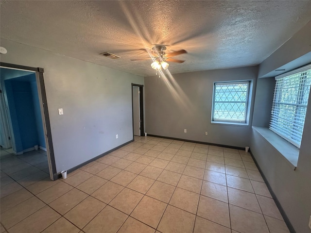 4522 Sage Cir, Baytown, TX 77521 - unfurnished room featuring ceiling fan, a textured ceiling, and light tile patterned floors