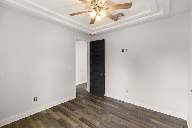 4819 Los Angeles St, Houston, TX 77026 - spare room featuring a tray ceiling, ceiling fan, and dark wood finished floors