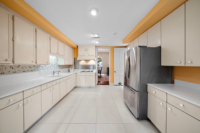 9 Farther Pt, Houston, TX 77024 - kitchen featuring light countertops, freestanding refrigerator, white cooktop, backsplash, and light tile patterned floors