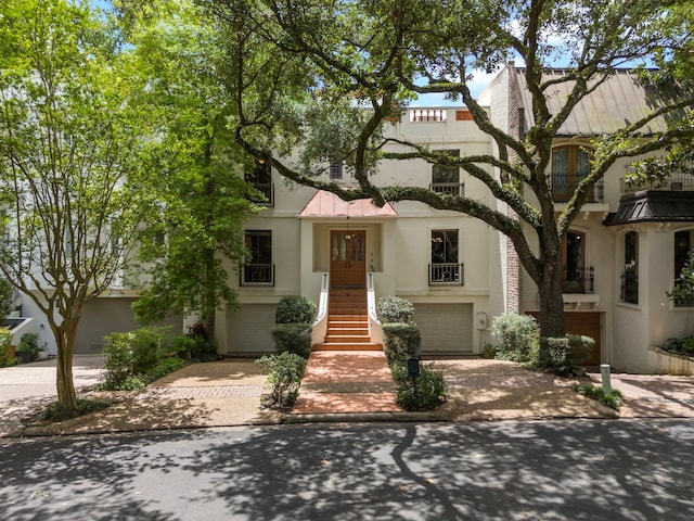 9 Farther Pt, Houston, TX 77024 - multi unit property with stucco siding, decorative driveway, and an attached garage