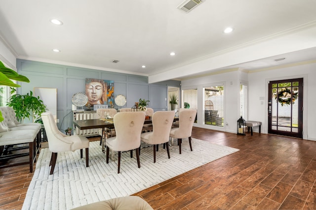 12422 Cobblestone Dr, Houston, TX 77024 - dining space with crown molding, dark wood-style floors, a decorative wall, and recessed lighting