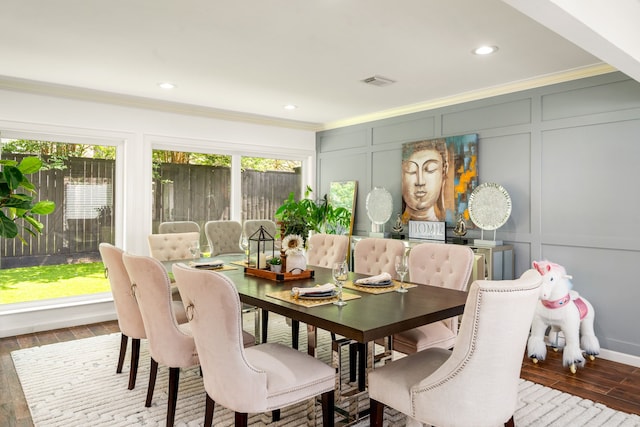 12422 Cobblestone Dr, Houston, TX 77024 - dining area featuring a decorative wall, ornamental molding, wood finished floors, and recessed lighting