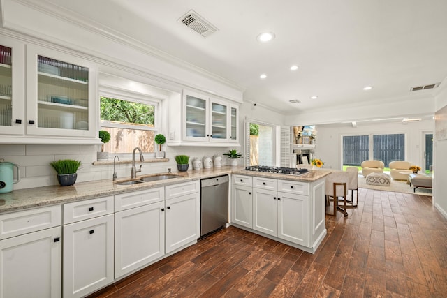 12422 Cobblestone Dr, Houston, TX 77024 - kitchen with stainless steel appliances, crown molding, a peninsula, recessed lighting, and white cabinetry