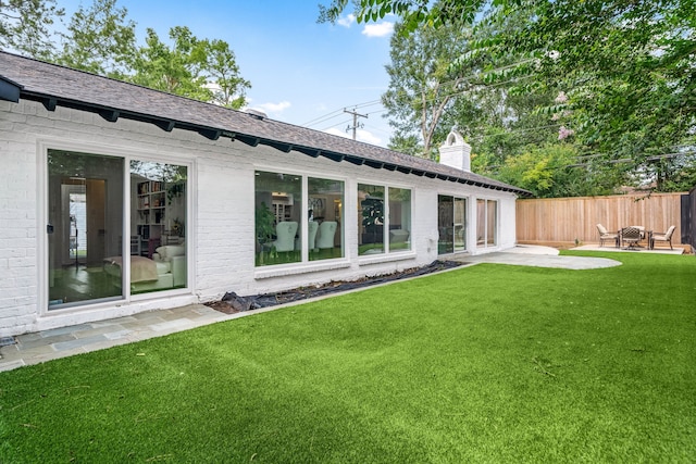 12422 Cobblestone Dr, Houston, TX 77024 - rear view of house featuring a patio area, a chimney, brick siding, and roof with shingles