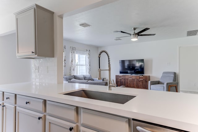 17814 Placid Oak Ct, Cypress, TX 77433 - kitchen with open floor plan, light countertops, ceiling fan, dishwashing machine, and decorative backsplash