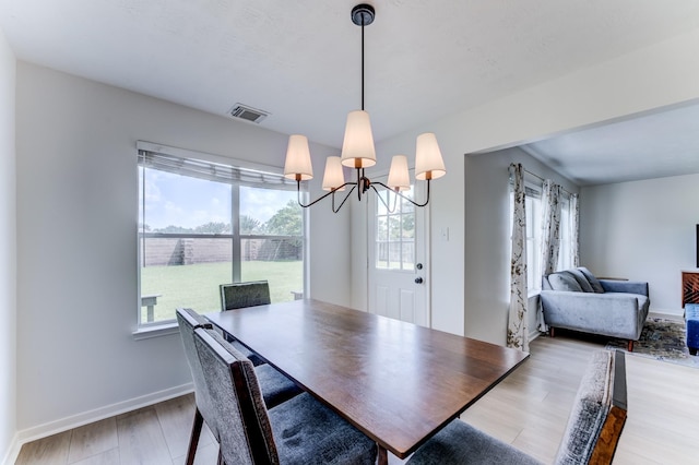 17814 Placid Oak Ct, Cypress, TX 77433 - dining space featuring healthy amount of natural light, a chandelier, and wood finished floors