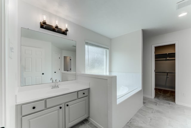 17814 Placid Oak Ct, Cypress, TX 77433 - full bath featuring a garden tub, vanity, a spacious closet, and marble finish floors