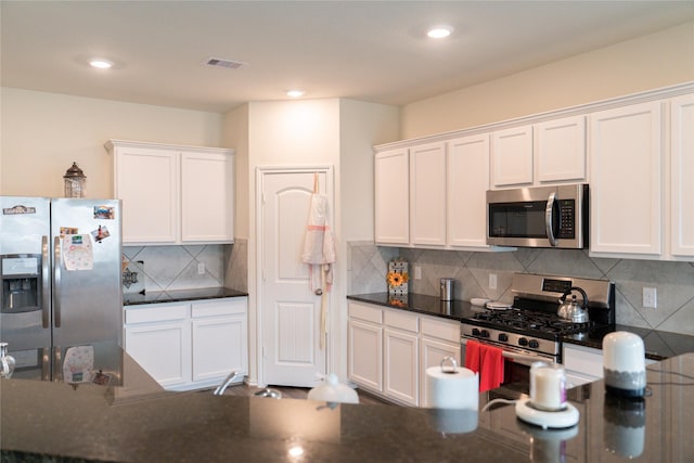 18802 Verdura Dr, New Caney, TX 77357 - kitchen featuring appliances with stainless steel finishes, white cabinetry, backsplash, and recessed lighting