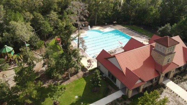 18802 Verdura Dr, New Caney, TX 77357 - aerial view of property and surrounding area with a pool area and a heavily wooded area
