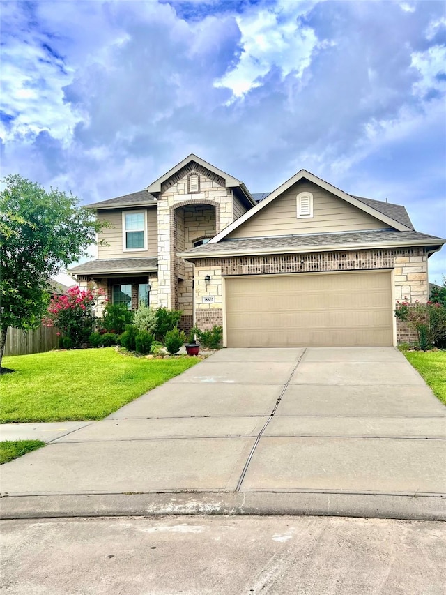 18802 Verdura Dr, New Caney, TX 77357 - view of front of property with a garage, driveway, stone siding, and a shingled roof